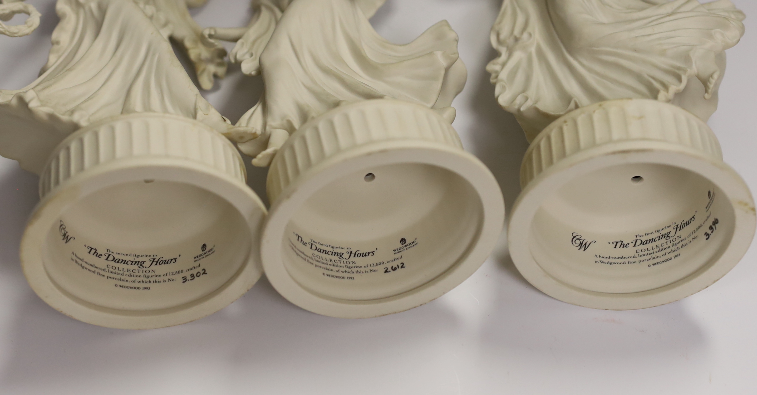 Three Wedgwood Dancing Hours figurines and a 19th century porcelain three graces centrepiece, largest 30cm high